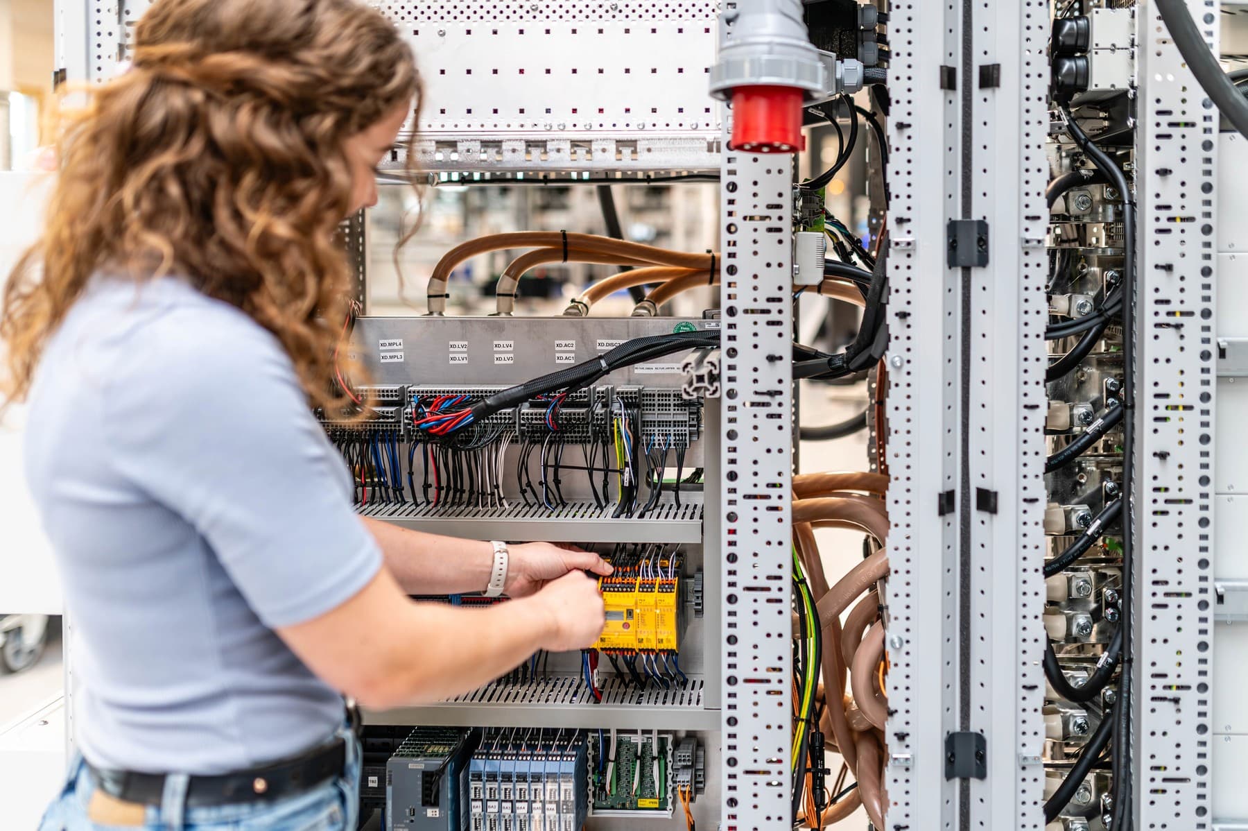 Employee wiring a control cabinet